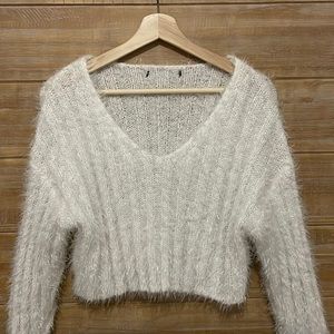 A white fuzzy cropped sweater